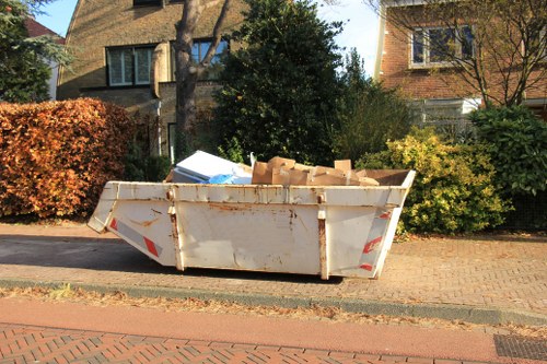 Man and van removing bulk garden debris in a semi-detached property